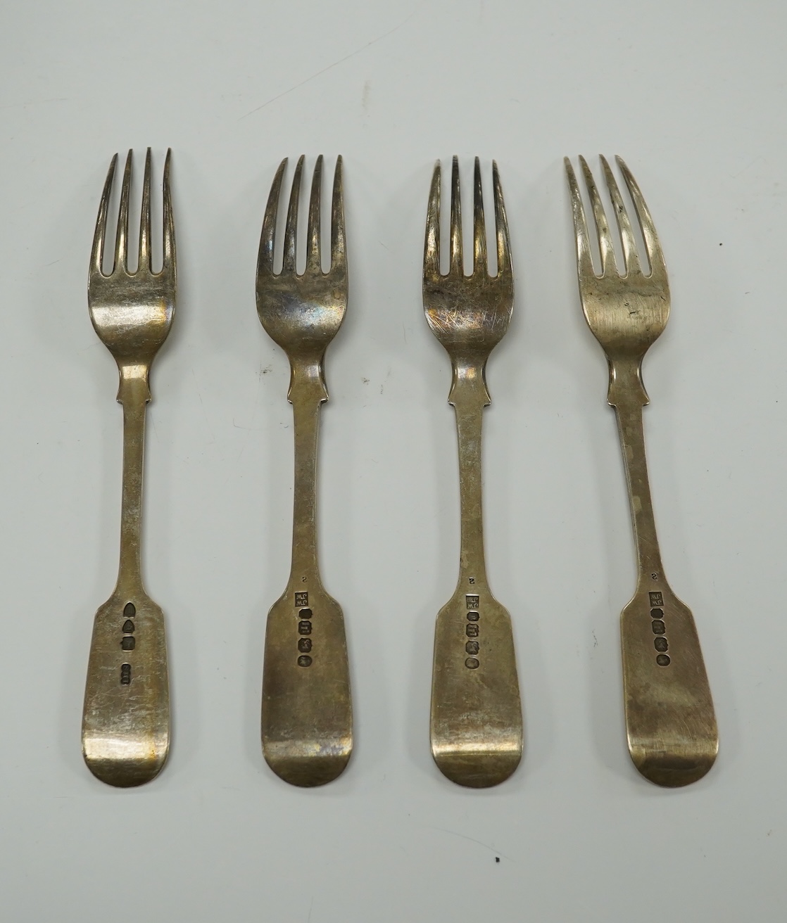 A Victorian harlequin part canteen of silver fiddle pattern flatware, various date and makers, 46.1oz. Condition - poor